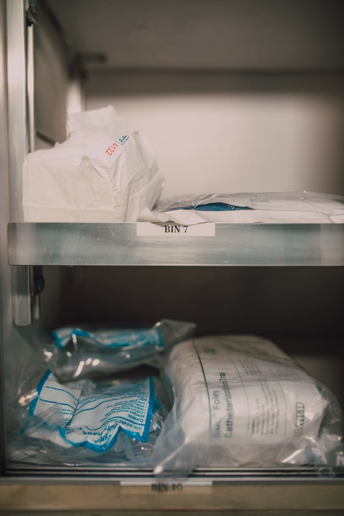 Medical supplies neatly organized in labeled storage bins in a healthcare setting.